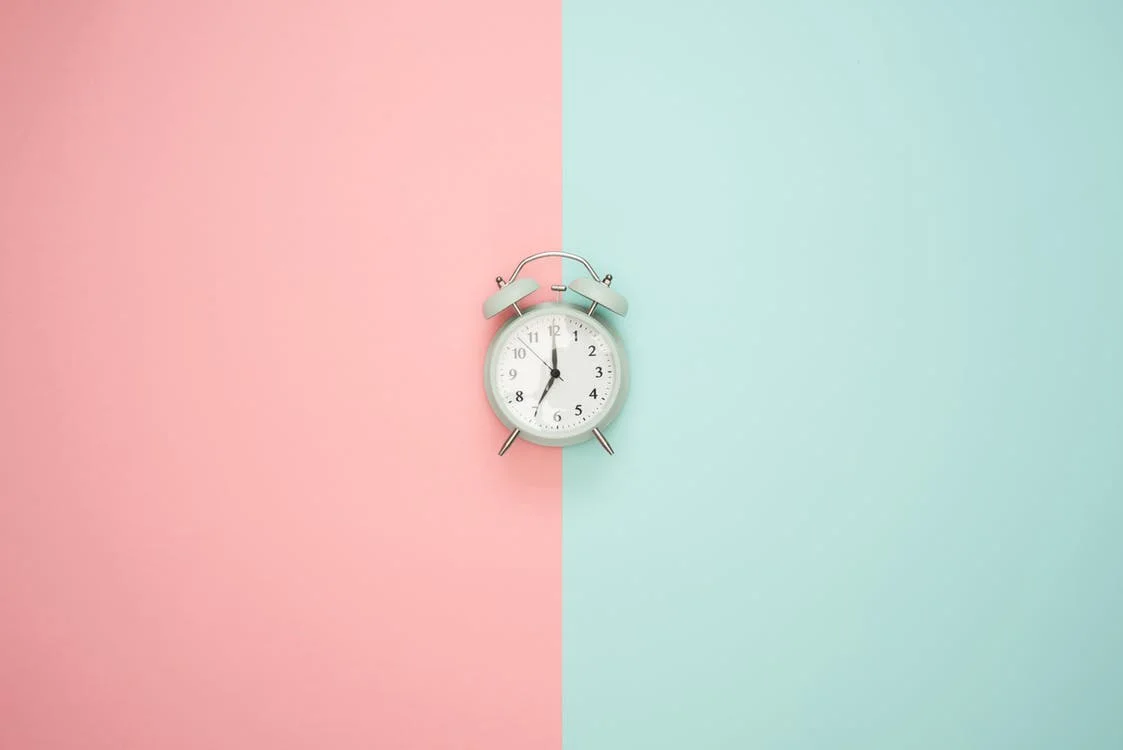 Alarm Clock on Blue and Pink Background