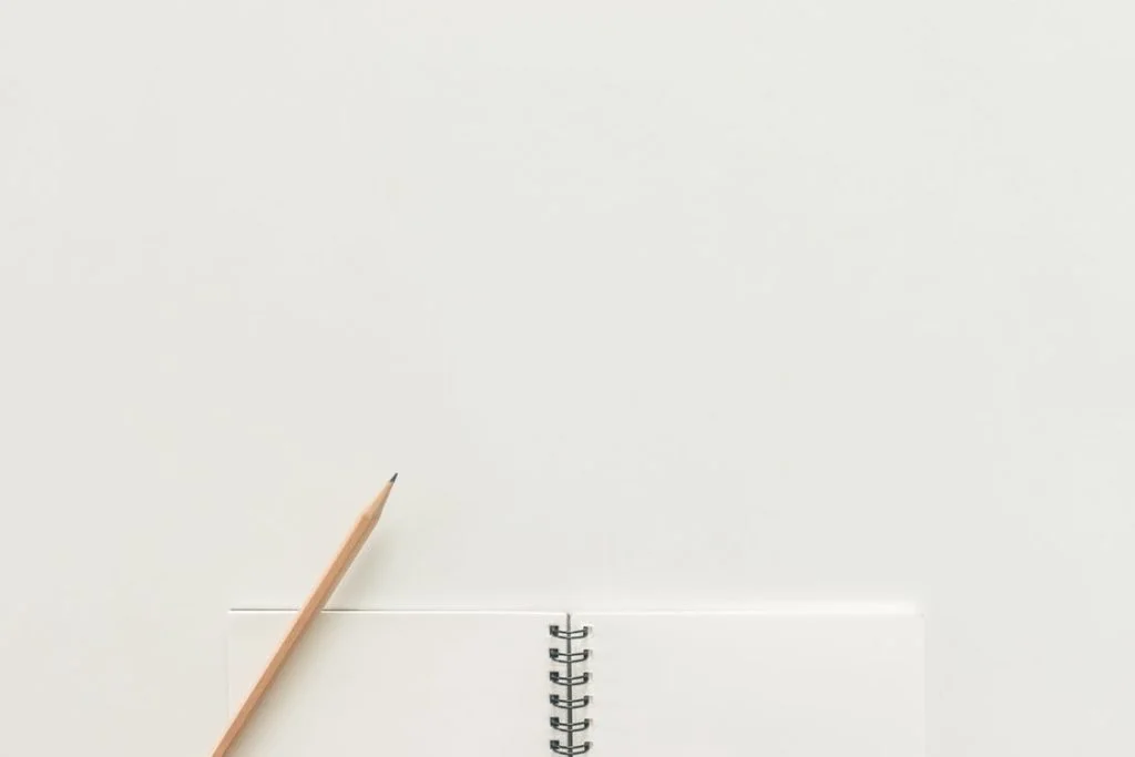 Pencil and Notebook on Table