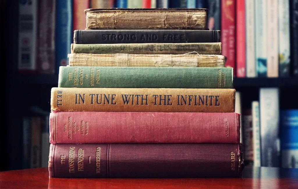 A Stack of Vintage Books With Faded Text and Wornout Covers