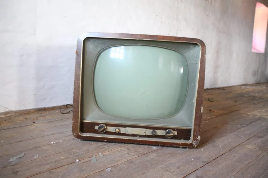 Old Television on the Wooden Floor